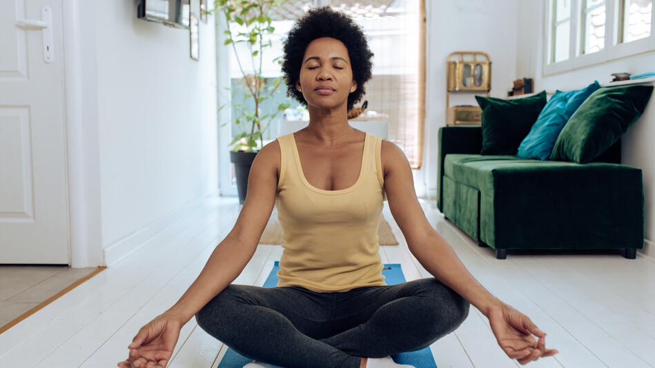 african american woman practicing meditation at home african american woman practicing meditation at home